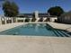 Sparkling community pool surrounded by a secure fence and desert landscaping at 18151 N 88Th Dr, Peoria, AZ 85382