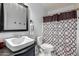 Bathroom with a white sink, toilet, mirror, and patterned shower curtain at 2112 E Minton Dr, Tempe, AZ 85282