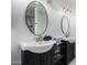 Bathroom featuring double sinks, round mirrors, and modern light fixtures at 2112 E Minton Dr, Tempe, AZ 85282