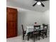 Dining room featuring dark wood cabinets, table with seating for four, and white tile floors at 2112 E Minton Dr, Tempe, AZ 85282