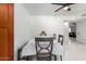 Dining area with dark-wood accents, a table, and a white door leading to another room at 2112 E Minton Dr, Tempe, AZ 85282