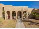 Charming facade with arched entries, secure wrought iron details, and well-manicured front yard at 2112 E Minton Dr, Tempe, AZ 85282