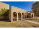 Charming facade with arched entries, secure wrought iron details, and well-manicured front yard at 2112 E Minton Dr, Tempe, AZ 85282