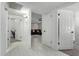 Hallway with multiple white doors and tile flooring leading to living areas at 2112 E Minton Dr, Tempe, AZ 85282