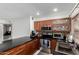 Cozy kitchen with granite counters, stainless steel appliances, and dark wood cabinets at 2112 E Minton Dr, Tempe, AZ 85282