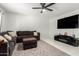 Bright living room featuring a comfortable sectional sofa, ceiling fan, and large-screen television at 2112 E Minton Dr, Tempe, AZ 85282