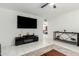 Bright living room featuring white marble flooring, large TV, and stylish decor on the console at 2112 E Minton Dr, Tempe, AZ 85282