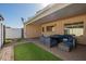 Inviting covered patio with stylish furniture and well-maintained artificial grass at 2112 E Minton Dr, Tempe, AZ 85282