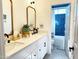 Well-lit bathroom featuring dual sinks, white countertops, and blue tiled shower for a modern design at 21491 S 185Th Way, Queen Creek, AZ 85142