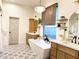 Bright bathroom featuring a modern soaking tub, dual vanities, and decorative tile flooring at 21491 S 185Th Way, Queen Creek, AZ 85142