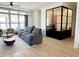 Comfortable living room featuring modern furnishings, a view of the backyard, and an adjacent office at 21491 S 185Th Way, Queen Creek, AZ 85142