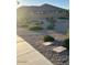 View of a fenced-in backyard with gravel and shrubbery at 21696 E Arroyo Verde Dr, Queen Creek, AZ 85142
