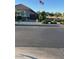 Street view of gray single-story home with US flag flying overhead at 21696 E Arroyo Verde Dr, Queen Creek, AZ 85142