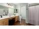 Bright bathroom featuring double sinks, a large vanity, and a shower/tub combo at 21740 W Sonora St, Buckeye, AZ 85326