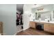 Bathroom with wood-look floors, double sinks, spacious closet and large vanity area at 21740 W Sonora St, Buckeye, AZ 85326