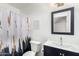 Bathroom with a blue vanity, modern sink, and a shower with a decorative curtain at 21740 W Sonora St, Buckeye, AZ 85326