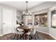 Cozy dining area with stylish lighting fixture, modern table, and a large window at 21740 W Sonora St, Buckeye, AZ 85326