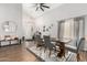 Bright dining room features wood floors, modern lighting, and gray chairs at a trestle table at 21740 W Sonora St, Buckeye, AZ 85326