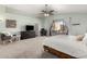 Bright main bedroom boasts a ceiling fan, carpet floors, and a view of the neighborhood at 21740 W Sonora St, Buckeye, AZ 85326