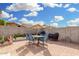 Expansive backyard featuring a brick patio with dining set, perfect for barbecues and gatherings at 22319 E Via De Olivos --, Queen Creek, AZ 85142