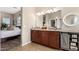 A bright bathroom featuring double sinks, granite counters and a large mirror at 22319 E Via De Olivos --, Queen Creek, AZ 85142