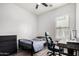 A simple bedroom featuring a dark dresser, bed, desk, and chair, providing a functional space for rest and work at 22319 E Via De Olivos --, Queen Creek, AZ 85142