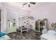 This bedroom features a white bunkbed, shelving, and a cozy space for relaxation and play, optimizing room functionality at 22319 E Via De Olivos --, Queen Creek, AZ 85142