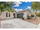 Beautfiul one-story house with an attached two-car garage and a long concrete driveway at 22319 E Via De Olivos --, Queen Creek, AZ 85142