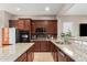 This kitchen features granite counters, stainless steel appliances and dark wood cabinets at 22319 E Via De Olivos --, Queen Creek, AZ 85142