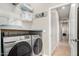 Modern laundry room featuring front load washer and dryer, with added shelf space above for maximum organization and convenience at 22319 E Via De Olivos --, Queen Creek, AZ 85142