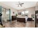 This main bedroom features wood floors, a ceiling fan and access to the backyard at 22319 E Via De Olivos --, Queen Creek, AZ 85142