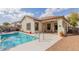 Backyard pool is surrounded by lush landscaping and features a covered patio for outdoor enjoyment at 22319 E Via De Olivos --, Queen Creek, AZ 85142