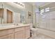 Inviting bathroom featuring a single sink vanity, decorative accents, and a shower-tub combo, providing a comfortable experience at 23106 N 146Th Ln, Sun City West, AZ 85375