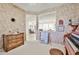 Decorated room with vintage floral wallpaper and an opening looking into other living areas in the home at 23106 N 146Th Ln, Sun City West, AZ 85375