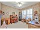 Vintage-style room with floral wallpaper, an antique organ, and shuttered windows creating a nostalgic and cozy atmosphere at 23106 N 146Th Ln, Sun City West, AZ 85375