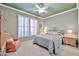 Charming bedroom featuring a comfortable bed, ceiling fan, shuttered windows, and side tables with lamps, a serene retreat at 23106 N 146Th Ln, Sun City West, AZ 85375