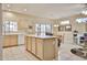 Spacious kitchen featuring an island, tile flooring, and ample counter space at 23106 N 146Th Ln, Sun City West, AZ 85375