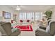 Bright living room features plantation shutters, neutral decor, and a comfortable seating arrangement at 23106 N 146Th Ln, Sun City West, AZ 85375