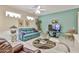 Bright living room with a ceiling fan, tile floors, and natural light, creating a welcoming atmosphere at 23106 N 146Th Ln, Sun City West, AZ 85375