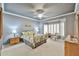 Tranquil bedroom featuring a tray ceiling, bay window with shutters, and stylish furnishings, offering a serene retreat at 23106 N 146Th Ln, Sun City West, AZ 85375