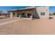 Home's backyard features a covered patio with ceiling fans and outdoor seating overlooking the property at 2349 W Skyline Ln, San Tan Valley, AZ 85144