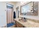 Bathroom featuring a rustic-framed mirror, granite countertops, and a tiled shower at 2349 W Skyline Ln, San Tan Valley, AZ 85144