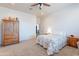 Bright bedroom with a ceiling fan, a view of the door, and a beautiful wooden cabinet at 2349 W Skyline Ln, San Tan Valley, AZ 85144