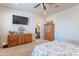 Bright bedroom with a ceiling fan, a view of the door, and a beautiful wooden dresser at 2349 W Skyline Ln, San Tan Valley, AZ 85144