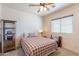 Cozy bedroom with plaid bedding, ceiling fan, and natural light at 2349 W Skyline Ln, San Tan Valley, AZ 85144