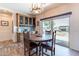 Dining area with wood table, cabinets, tile backsplash, and sliding glass doors to the back yard at 2349 W Skyline Ln, San Tan Valley, AZ 85144