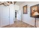 Hallway featuring rustic decor, wood-look floors, and access to multiple rooms at 2349 W Skyline Ln, San Tan Valley, AZ 85144