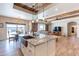 Open kitchen with granite counters, copper sink, wood beams, and stainless appliances at 2349 W Skyline Ln, San Tan Valley, AZ 85144