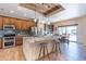 Kitchen with granite counters, stainless appliances, wood cabinets, tile backsplash, and a dining area at 2349 W Skyline Ln, San Tan Valley, AZ 85144