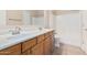 Bathroom with double vanity, framed mirror, and tub with tile surround at 2530 W Gaby Rd, Phoenix, AZ 85041